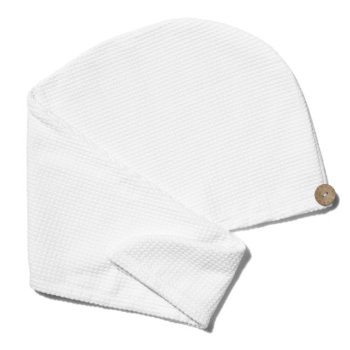 White towel or cloth, folded with a small brown button on it.