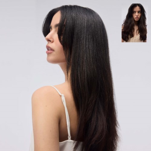 A woman with long, straight, shiny black hair looks to the side, wearing a light-colored top against a plain background.