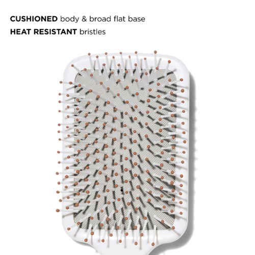 A white brush with a cushioned body and heat-resistant bristles, designed for cleaning or grooming.