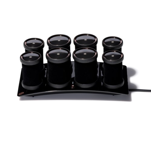 A black device with eight circular glass containers, connected to a power cord, likely a tea or coffee warmer.