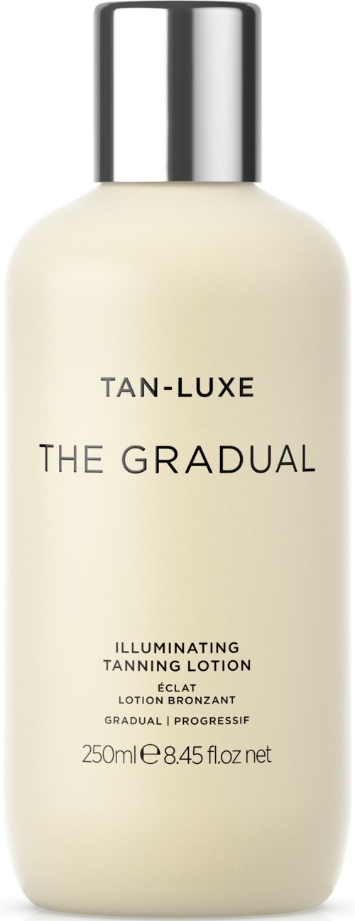 A white bottle with a silver cap that says 'Tan-Luxe The Gradual Illuminating Tanning Lotion.'