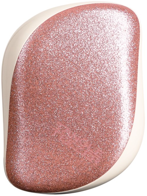 En glänsande rosa-brun makeup-svamp med glitter, oval form och en vit bas.