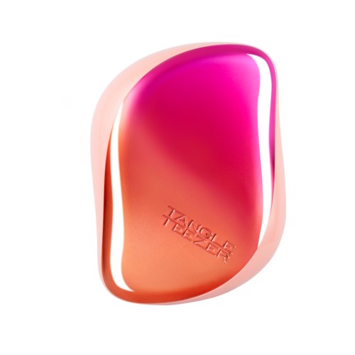 Ett rosa och orange föremål med orden "TANGLE TEEZER" inpräglat. Det har en böjd, ergonomisk form.