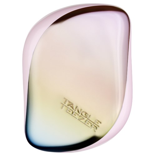 A shiny, rounded object with a soft pink border and a gold Tangle Teezer logo.