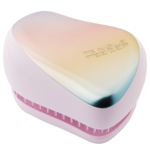 A pink and white heart-shaped device with tone scale, labeled "TANGLE TEEZER," used for hair brushing.