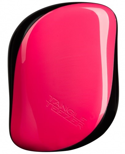 En rosa och svart hårborste med texten "Tangle Teezer" intryckt på den.