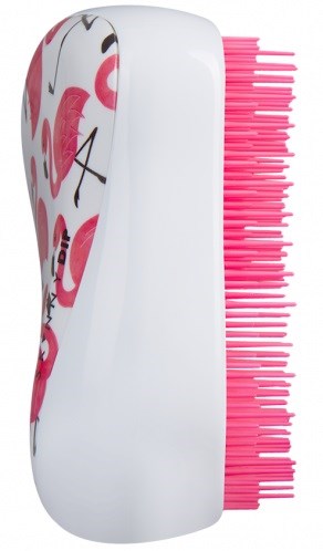 En vit borste med rosa borst och flamingomönster på handtaget.