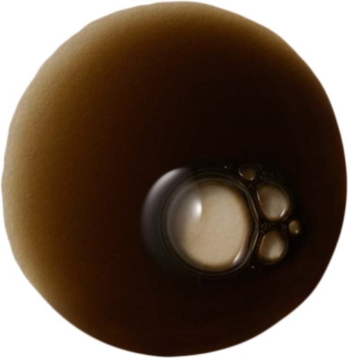 A round object with a dark interior, showing some bubbles or liquid at the bottom.