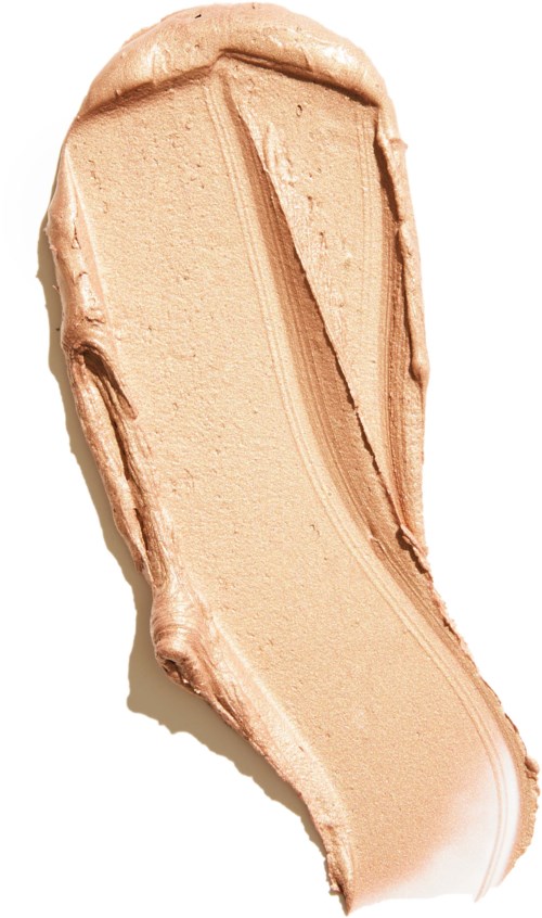 A beige, smooth, curved swatch of makeup or foundation with textured edges.