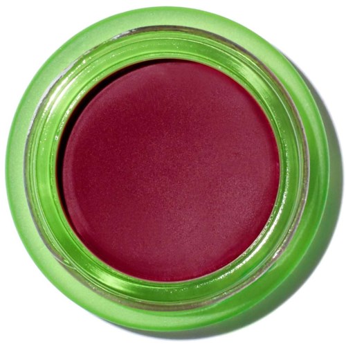 A round makeup container with green edges and maroon-colored lipstick inside.