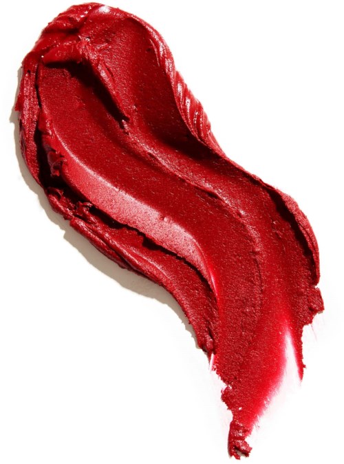 Red lipstick smudge with a shiny, smooth texture on a white background.