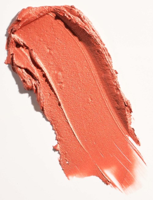 A smear of peach-colored makeup or lipstick on a white background.
