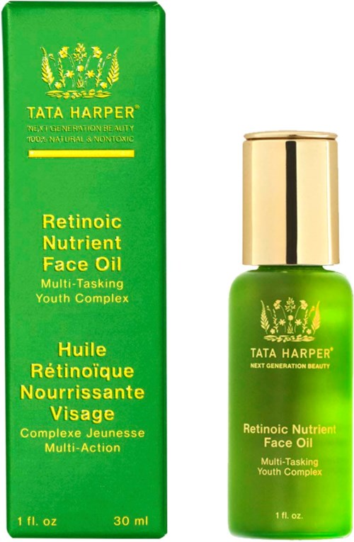 Green box and bottle of face oil, labeled Tata Harper, with a gold cap and youthful skincare description.
