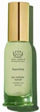 Green bottle with a gold cap, labeled Tata Harper Superkind skin serum for brightening and aging.