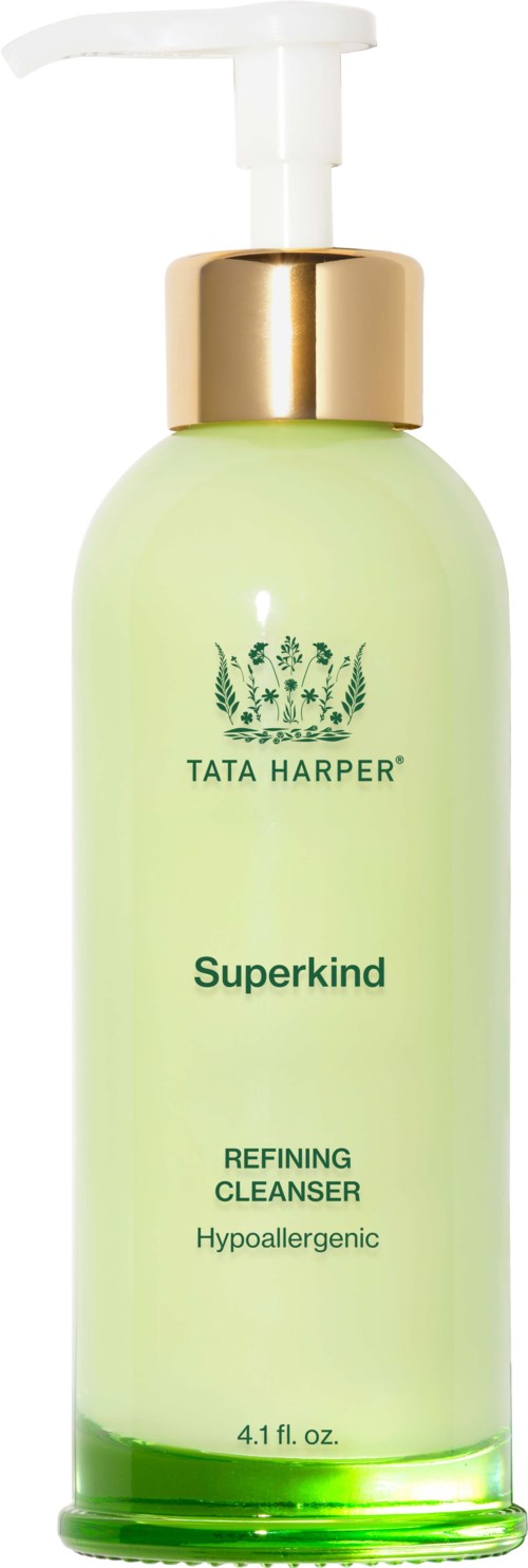 A light green bottle with a white pump and gold collar, labeled "Tata Harper Superkind" refining cleanser.