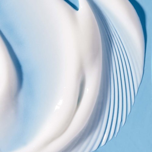 Abstract close-up of a white, wavy object with blue accents and fine lines in the design.