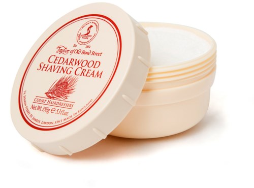 A small, round container of cedarwood shaving cream with a lid. The label is white with red text and logo.