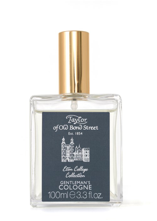 A clear perfume bottle with a gold cap, label shows 'Taylor of Old Bond Street' and 'Eton College Collection'.