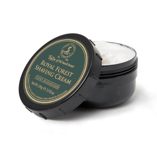 A black round container with a label saying 'Royal Forest Shaving Cream', filled with white shaving cream.