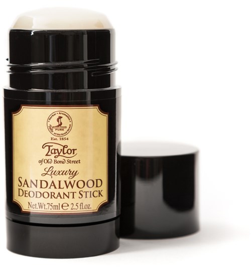 En svart deodorantstiftbehållare med ljus etikett, öppen med locket vid sidan av, som visar produkten inuti.