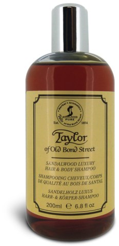 En brun flaske med Taylor sandalwood luksuriøst hår- og kroppsshampoo med beige etikett og svart hette.
