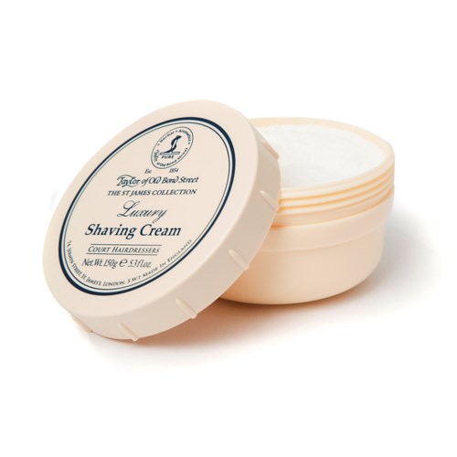 A round container of luxury shaving cream with a label on the lid, open to show white cream inside.