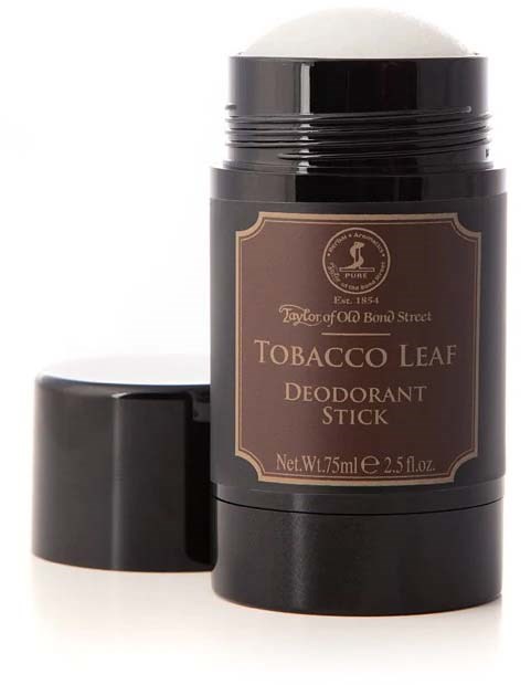 A black deodorant stick with a brown label and cap, labeled as tobacco leaf scent.
