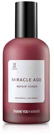 A pink bottle of Miracle Age Repair Toner with a black cap, labeled with brand and product details.