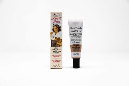 Een tube vloeibare concealer naast de verpakking, beiden met een vintage vrouwenillustratie en productgegevens.