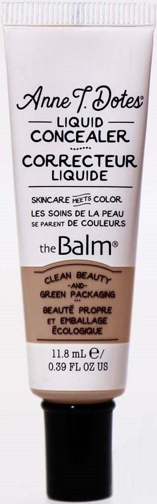 Eine Tube Concealer mit schwarzem Deckel, weiße und beige Verpackung, mit Textbeschreibung des Produkts und der Marke.