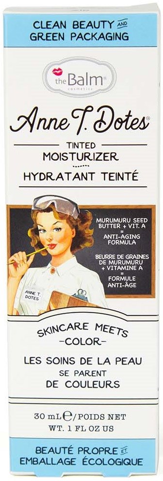 En ask med färgad ansiktskräm från the Balm, med en vintageillustration av en kvinna som sminkar sig och text om ingredienser.