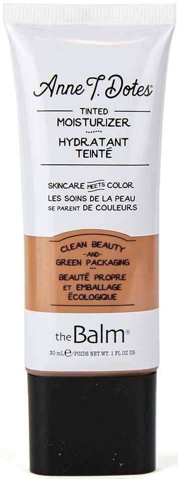Tub med tonad fuktighetskräm med svart lock, vit-och-beige etikett och text som beskriver produkten.