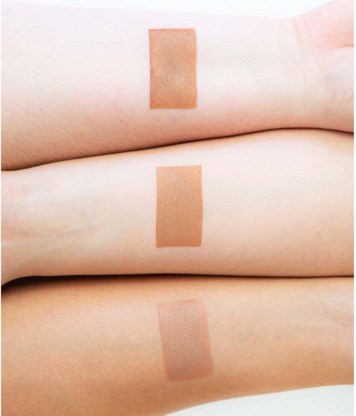 Three skin-colored adhesive patches on light skin, arranged in a vertical line.