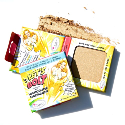 Three small boxes of blush and a beige makeup sponge with some loose powder on a white surface.