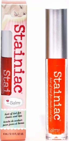Lippen-en wangstift met zilveren dop, oranje kleur, verpakking met afbeelding van een vrouw en merknaam.