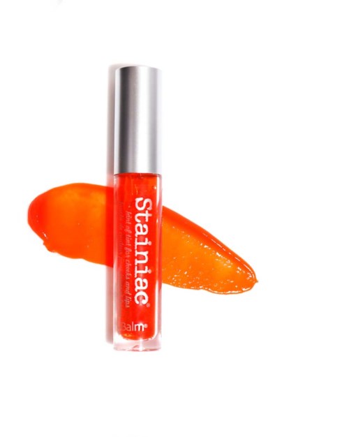 Lippenbalsem met oranje gel in doorzichtig tube, met een oranje streep erachter.