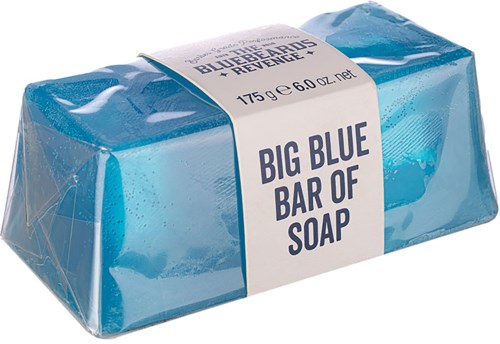 A large blue soap bar is wrapped in clear plastic with a white label. The label says "BIG BLUE BAR OF SOAP."