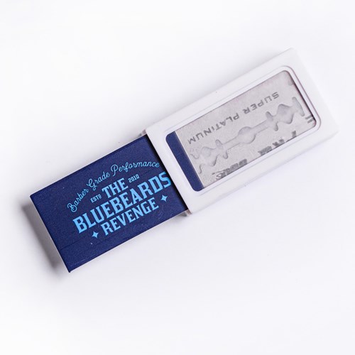 A box cutter with a blue cover titled "Bluebeard's Revenge" in white and blue text, and a silver blade inside.