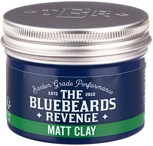 A small, round container with a silver lid and blue body. It is labeled 'The Bluebeards Revenge Matt Clay'.