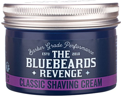 A round container with a silver lid and blue label. It is labeled as "The Bluebeards Revenge" Classic Shaving Cream.