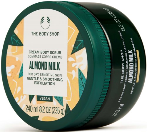 Vihreä pyöreä purkki The Body Shopin mantelimaitokuorinnalle kuivalle iholle, 240 ml, vegaaninen, lehti- ja oranssisuunnittelu.