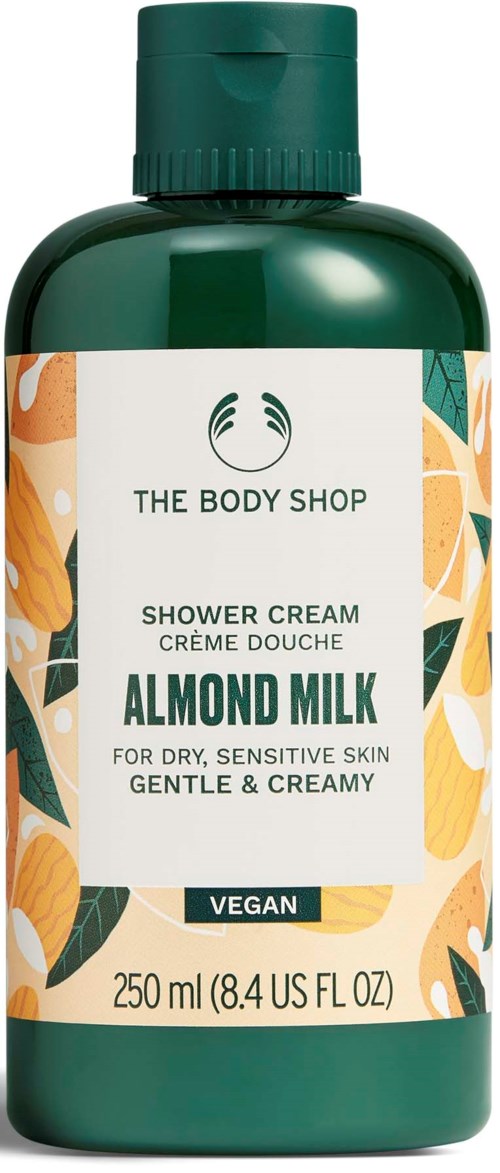 Green bottle of almond milk shower cream with floral design, suitable for dry, sensitive skin, gentle, vegan.