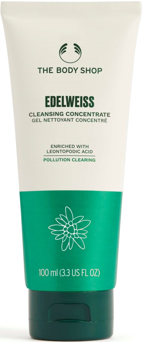 Eine weiße und grüne Tube mit The Body Shop Edelweiss Cleansing Concentrate. Es hat Blumen- und Textdetails auf der Verpackung.