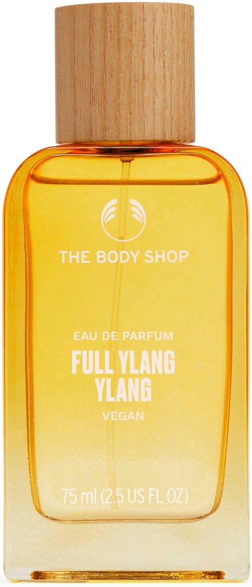 Eine kleine Flasche vom The Body Shop Parfüm mit Holzdeckel, gelber Flüssigkeit und weißen Text.