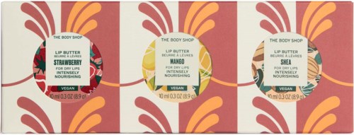 Box mit drei Lippenbalsam-Containern in Erdbeer-, Mango- und Shea-Düften, mit bunten Blättern und Blumenmotiven.