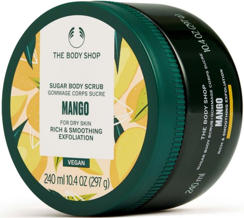 Ein grüner Behälter mit Mango-Duft-Körperscrub von The Body Shop, für trockene Haut, mit tropischer Zitrus- und Mangonmarkierung.