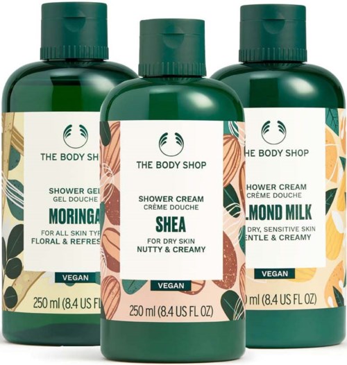 Three green bottles of shower cream with different scents: Moringa, Shea, and Almond Milk, from The Body Shop, vegan.