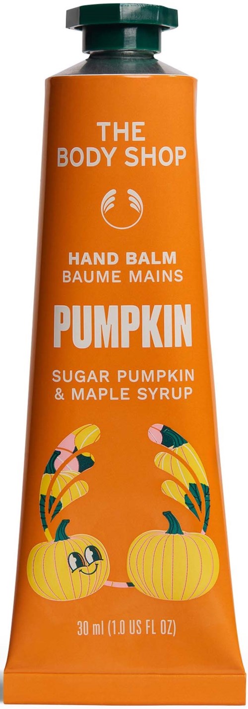 Orange pumpkin-themed hand balm tube with a green cap, featuring smiling pumpkins and leaves on the packaging.