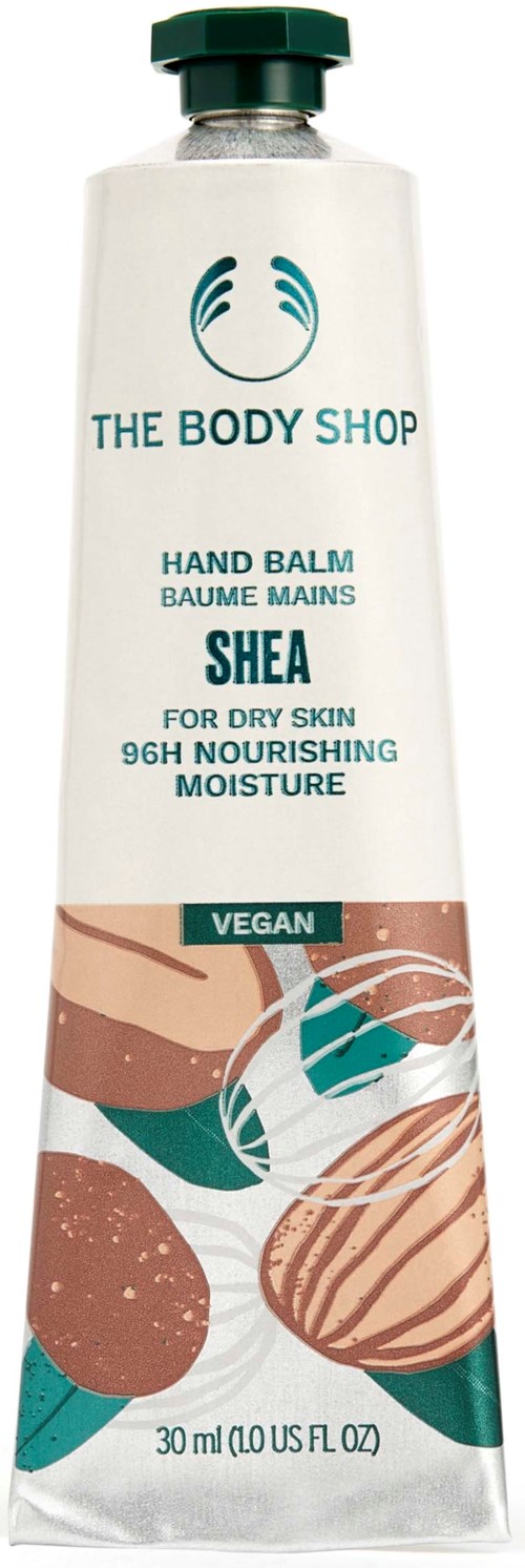 A tube of hand balm labeled 'The Body Shop' with shea butter for dry skin and vegan ingredients.
