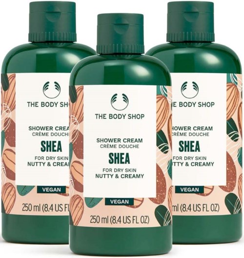 Three bottles of Shea shower cream with vegan label, designed for dry, nutty, and creamy skin.